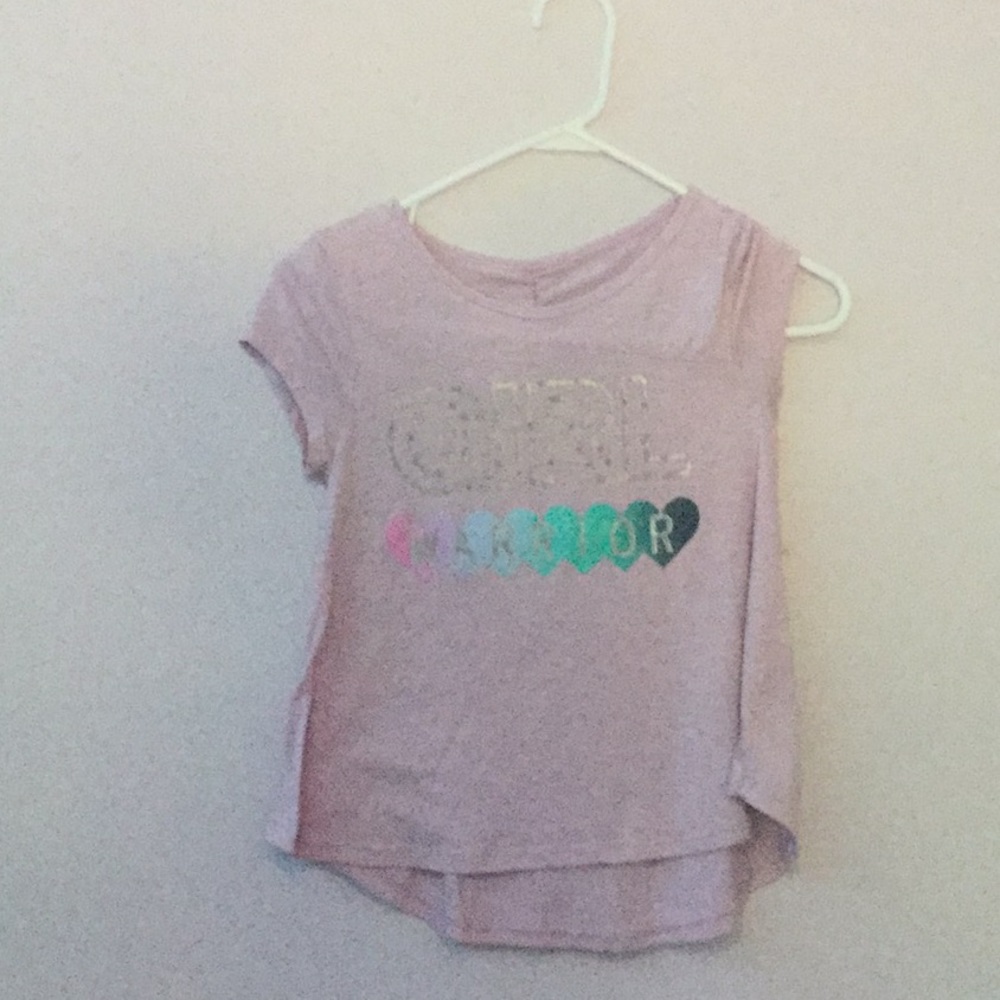 A purple Tee shirt that says girl warrior.